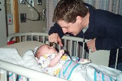 Daddy makes Jack laugh in the crib
